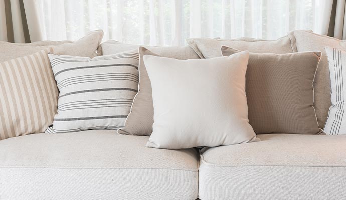 Clean throw pillows on a comfortable sofa.
