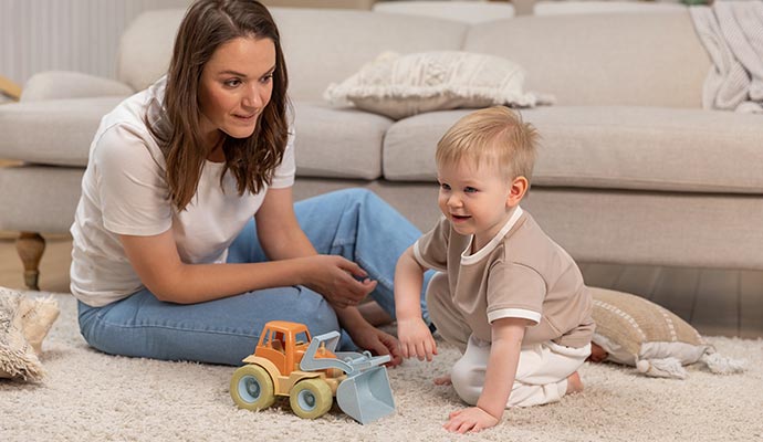 Mother and baby playing on a clean carpet
