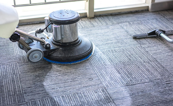rotary floor scrubber cleaning gray patterned carpet